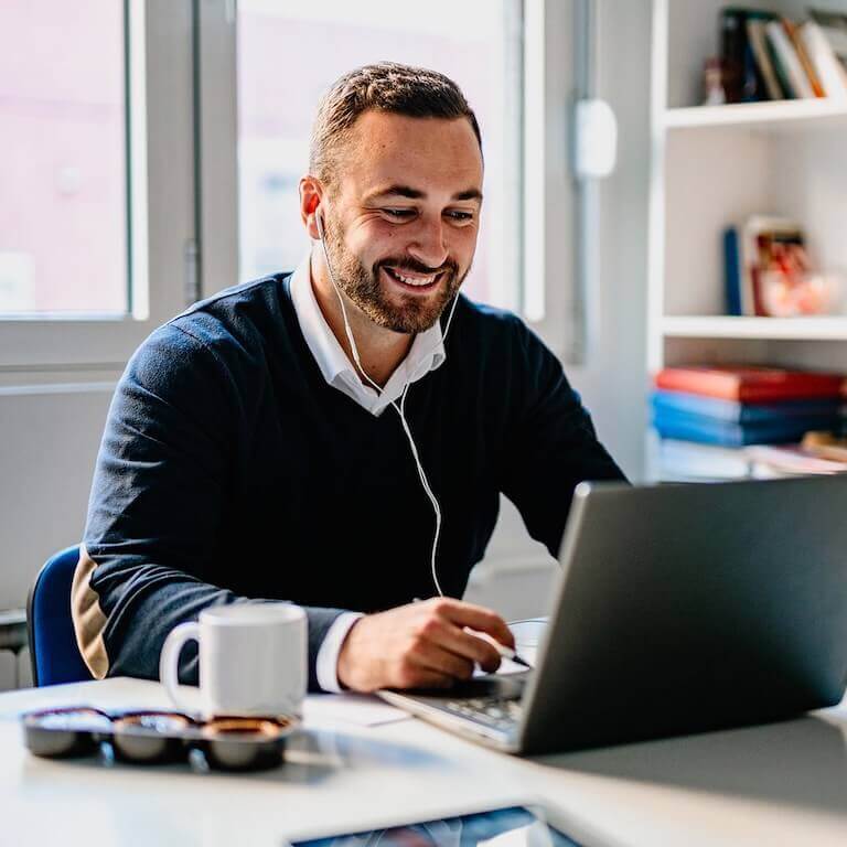 Man with headphone looking at laptop