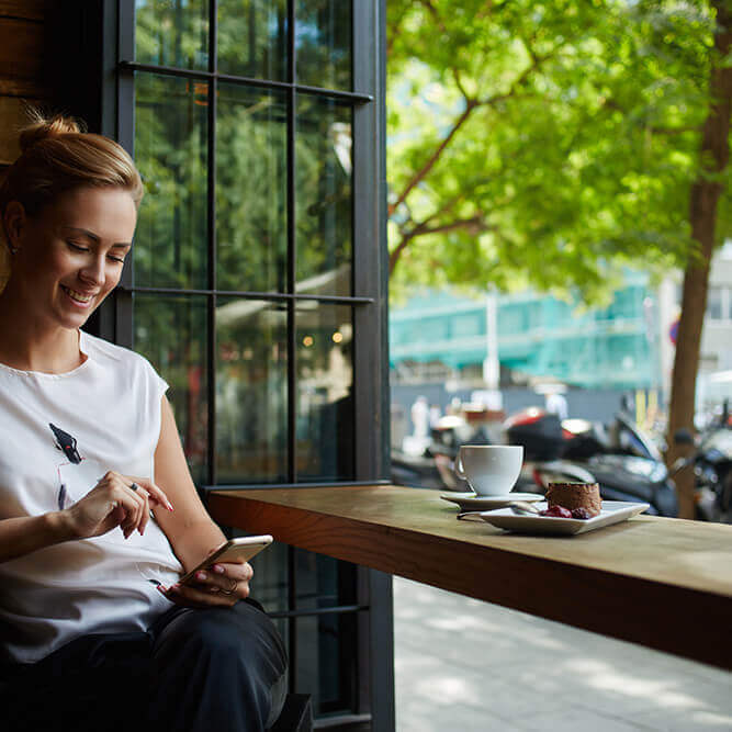 lady on mobile phone in cafe