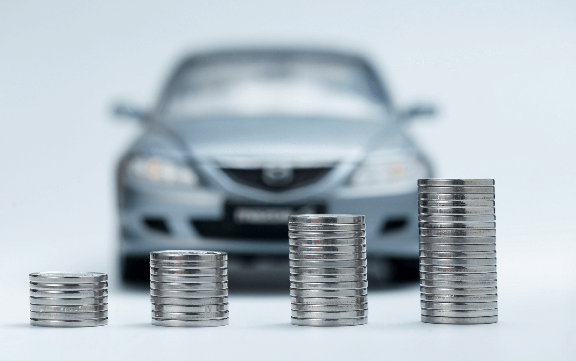 coins stacked in front of car