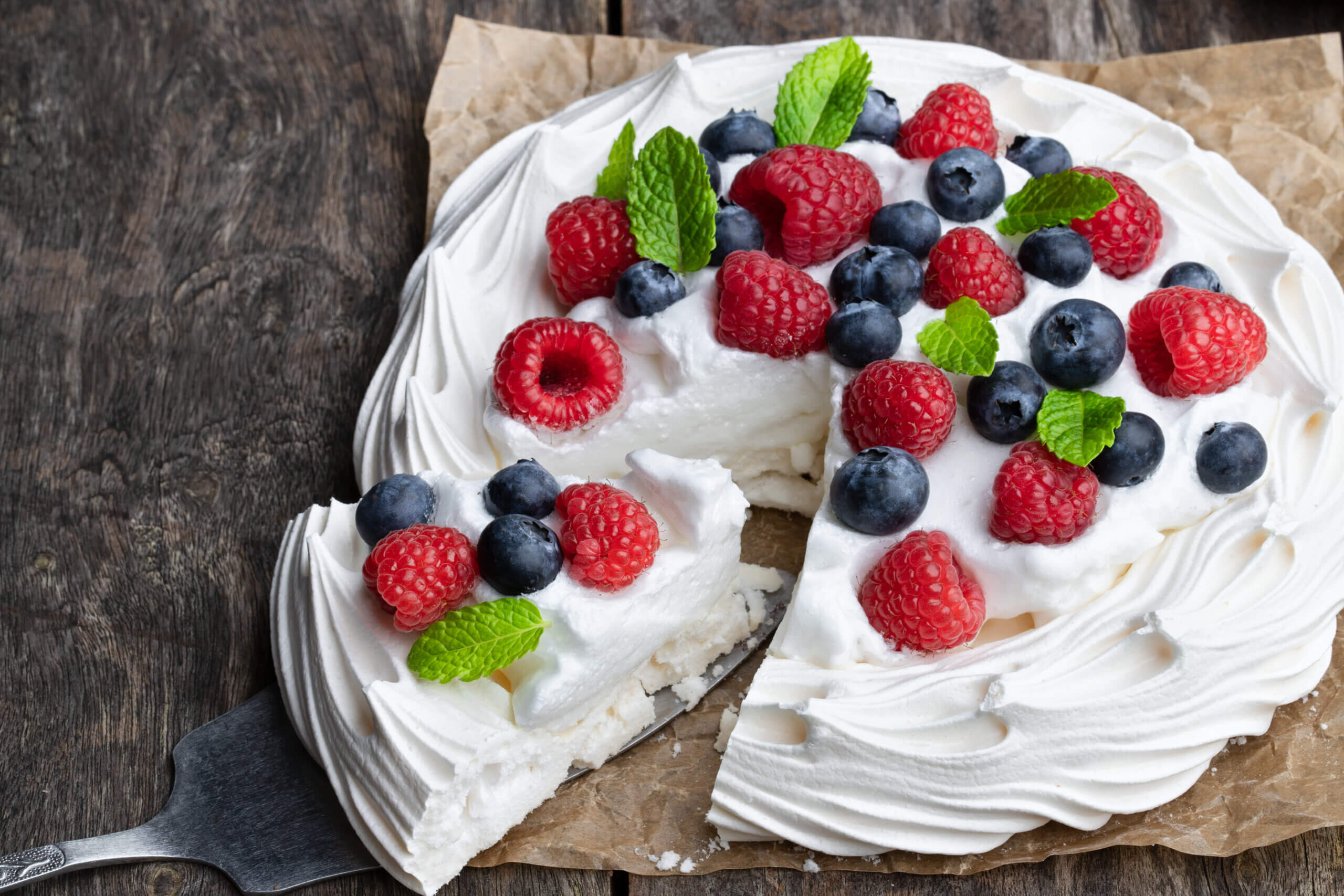 Pavlova with berries and mint leaves