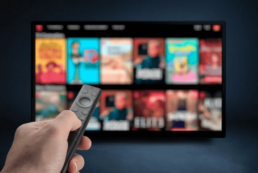 man with remote selecting a movie